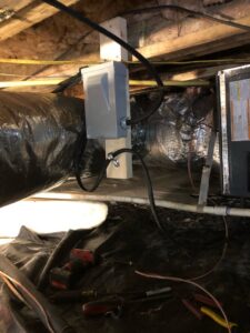 HVAC ductwork and electrical connections being installed in a crawl space by Workman Mechanical in Graham, NC.