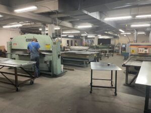 A worker fabricating sheet metal ductwork in the workshop at HVAC Solutions in Colorado Springs, CO