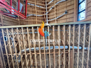 HVAC ductwork installed within the wooden framing of a new construction project by Comfort Temp HVAC LLC in Fort Smith, AR
