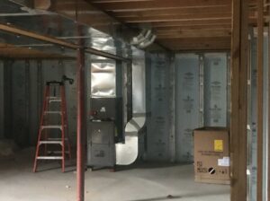 HVAC ductwork and a furnace unit being installed in a basement by Accurate Conditioning in Sayreville, NJ.