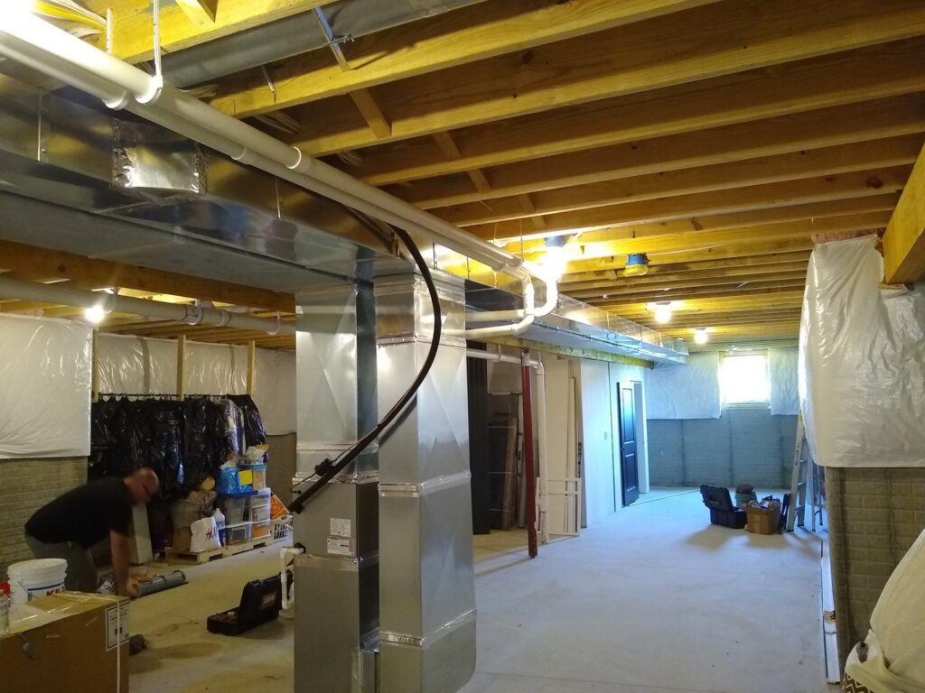 New HVAC ductwork and furnace installation in a basement by Wyles Heating & Air Conditioning Inc. in North Canton, OH.