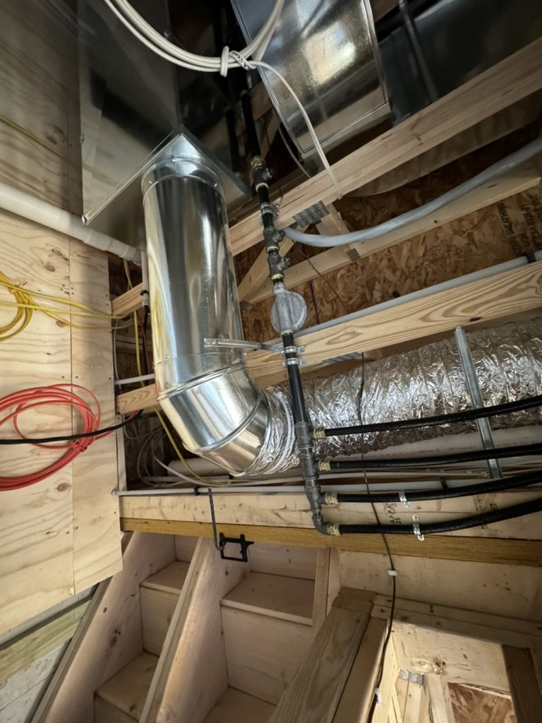 New HVAC ductwork and gas line installation in a basement or utility area by Dischler Heating-Cooling & Fireplaces in Prairie du Sac, WI.