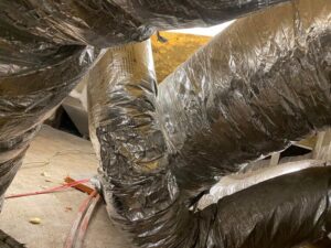 Newly installed or repaired HVAC ductwork visible in an attic space by Merriam Elite Solutions in Satsuma, AL.