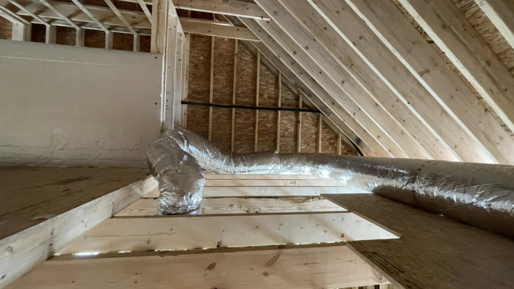 HVAC ductwork installation in an unfinished attic by Paul Mechanical LLC in Merrimack, NH