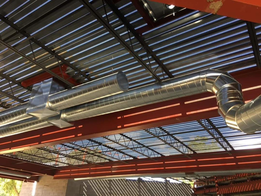 Newly installed HVAC ductwork in a commercial building by Boardwell Mechanical Services Inc. in Montague, MI
