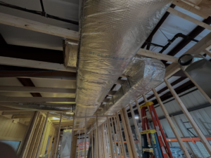 Insulated HVAC ductwork being installed in a new construction building by BRI Mechanical in Charleston, WV
