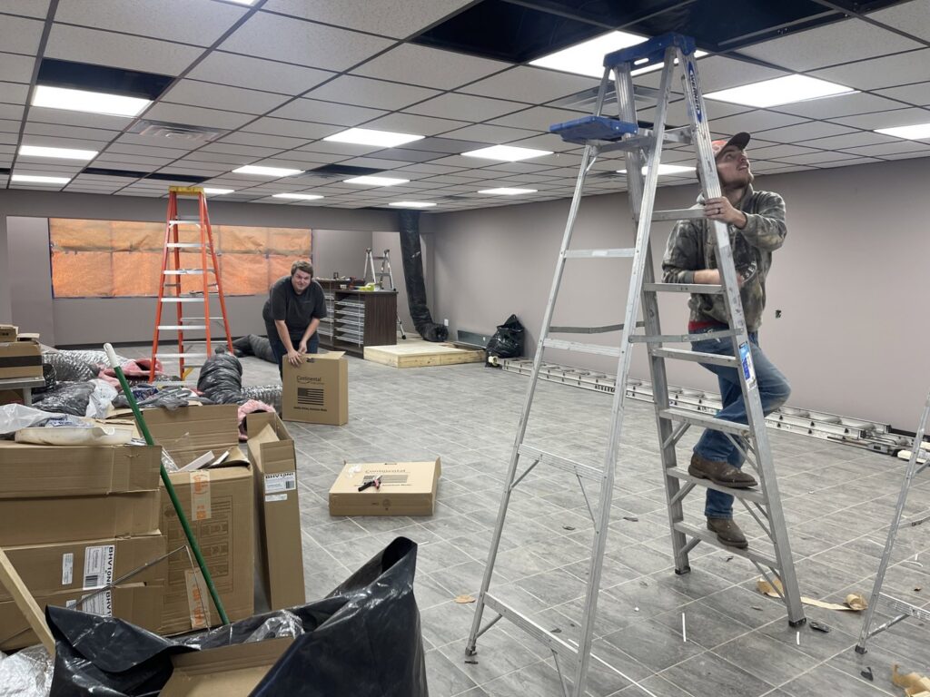 Wes-Tech Services technicians installing new HVAC ductwork in a commercial building in Bloomington, IN.