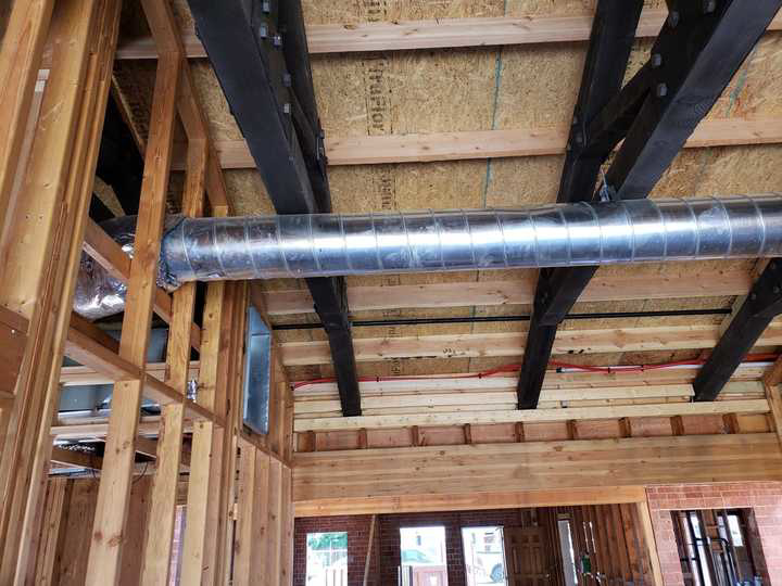 New HVAC ductwork being installed in a framed building under construction by A+ Air and Aeroseal in Scottsdale, AZ.