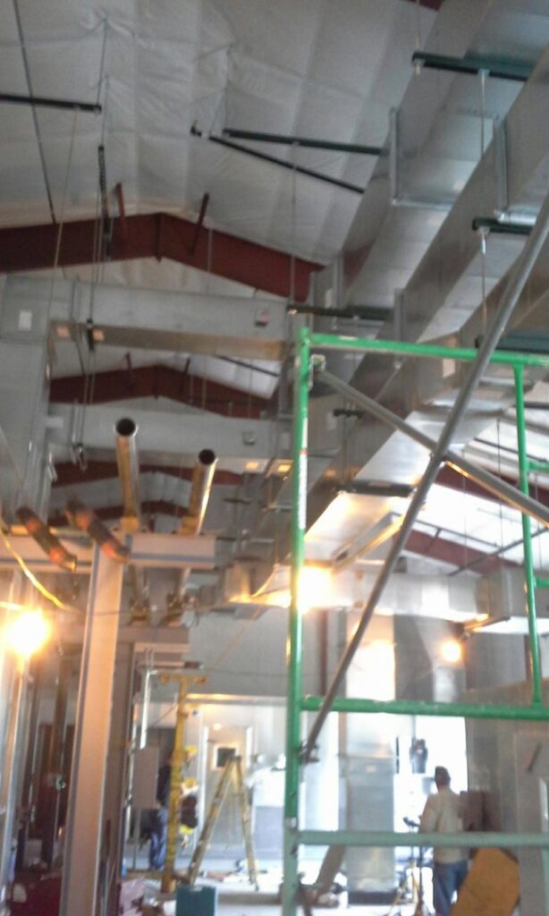 HVAC ductwork being installed in a commercial building under construction by Montefusco HVAC in Peoria, IL