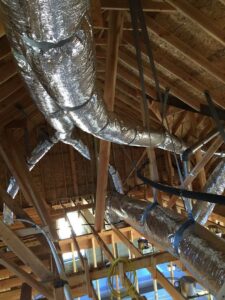 Extensive HVAC ductwork being installed in the ceiling of a building under construction by Prudhom Mechanical LLC in Edmond, OK