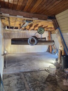 Large brown HVAC ductwork installed in a room under construction by Rivertech Heating & Air Conditioning in Chattanooga, TN.