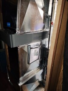 Detailed view of new HVAC ductwork connected to a unit, showcasing professional installation by Evergreen HVAC Comfort Solutions in Milwaukee, WI.