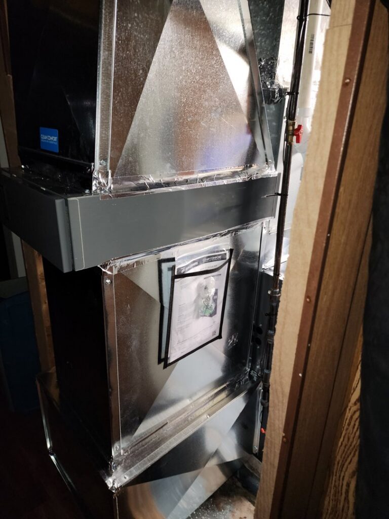 Detailed view of new HVAC ductwork connected to a unit, showcasing professional installation by Evergreen HVAC Comfort Solutions in Milwaukee, WI.