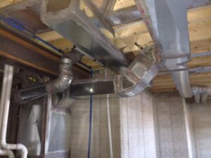 HVAC ductwork installation in a basement or crawl space by R.J. Nelson Co in Council Bluffs, IA.