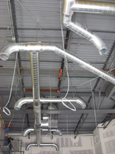 HVAC ductwork installation in progress in a large commercial building by DC AC Air Conditioning & Heating in San Diego, CA.
