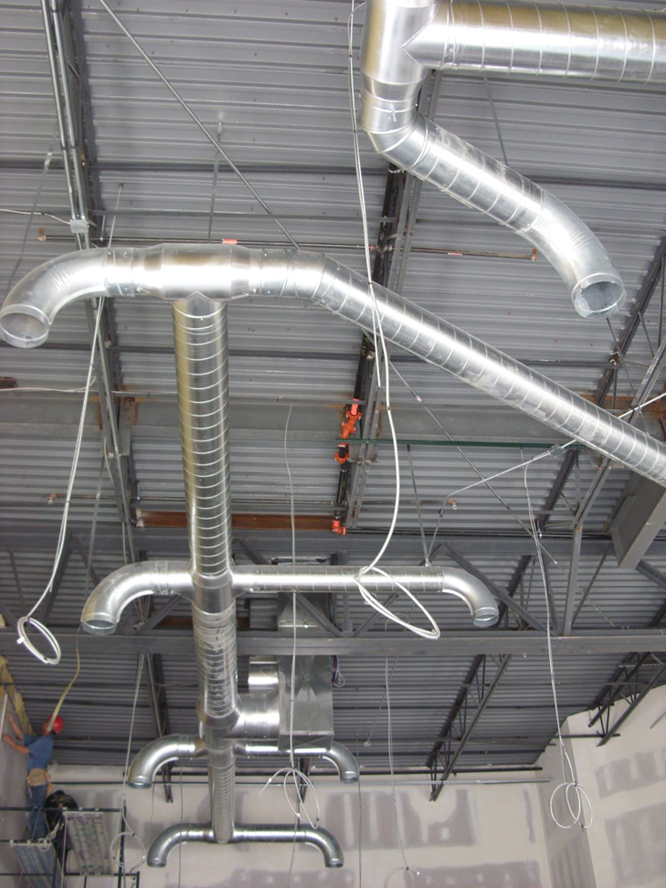 HVAC ductwork installation in progress in a large commercial building by DC AC Air Conditioning & Heating in San Diego, CA.