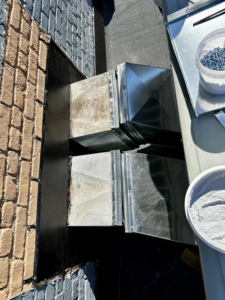 New and existing HVAC ductwork components on a rooftop during an installation by Air Conditioning Experts in Orlando, FL.