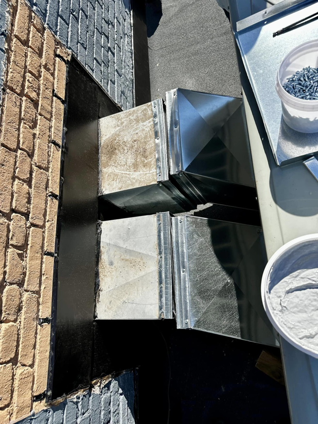 New and existing HVAC ductwork components on a rooftop during an installation by Air Conditioning Experts in Orlando, FL.