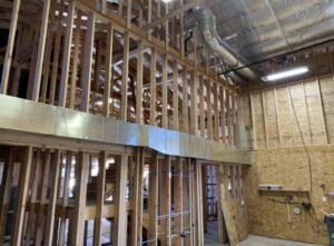 New HVAC ductwork installed within the framing of a building under construction by AP HVAC in Ridgewood, NY.