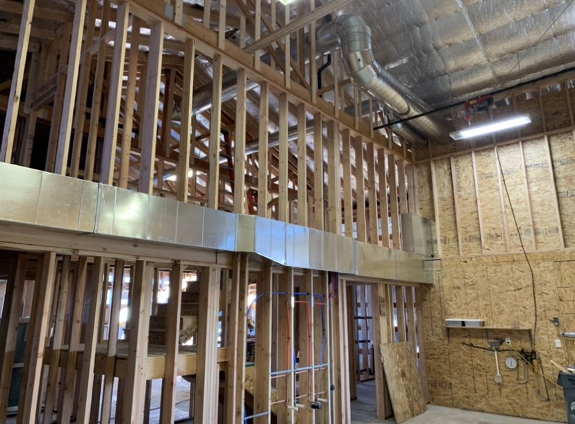 New HVAC ductwork installed within the framing of a building under construction by AP HVAC in Ridgewood, NY.