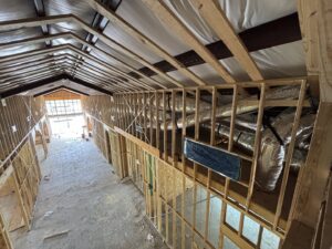 HVAC ductwork installation visible in a new construction building by Community Mechanical in Plano, TX.