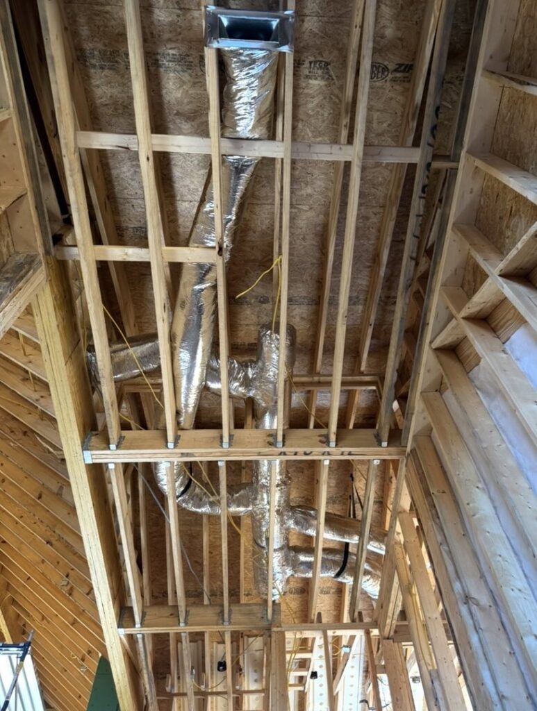 Extensive HVAC ductwork being installed in the ceiling of a new home construction project by Triune Air in Smithville, TN.