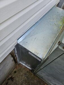 Close-up of metal HVAC ductwork installation next to a home by Parker's Heating & Cooling in Murfreesboro, TN