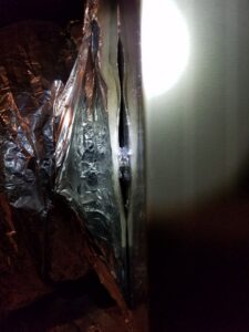 Close-up of insulated HVAC ductwork, possibly during installation or repair by Reliance Home Comfort in Hampton, VA.