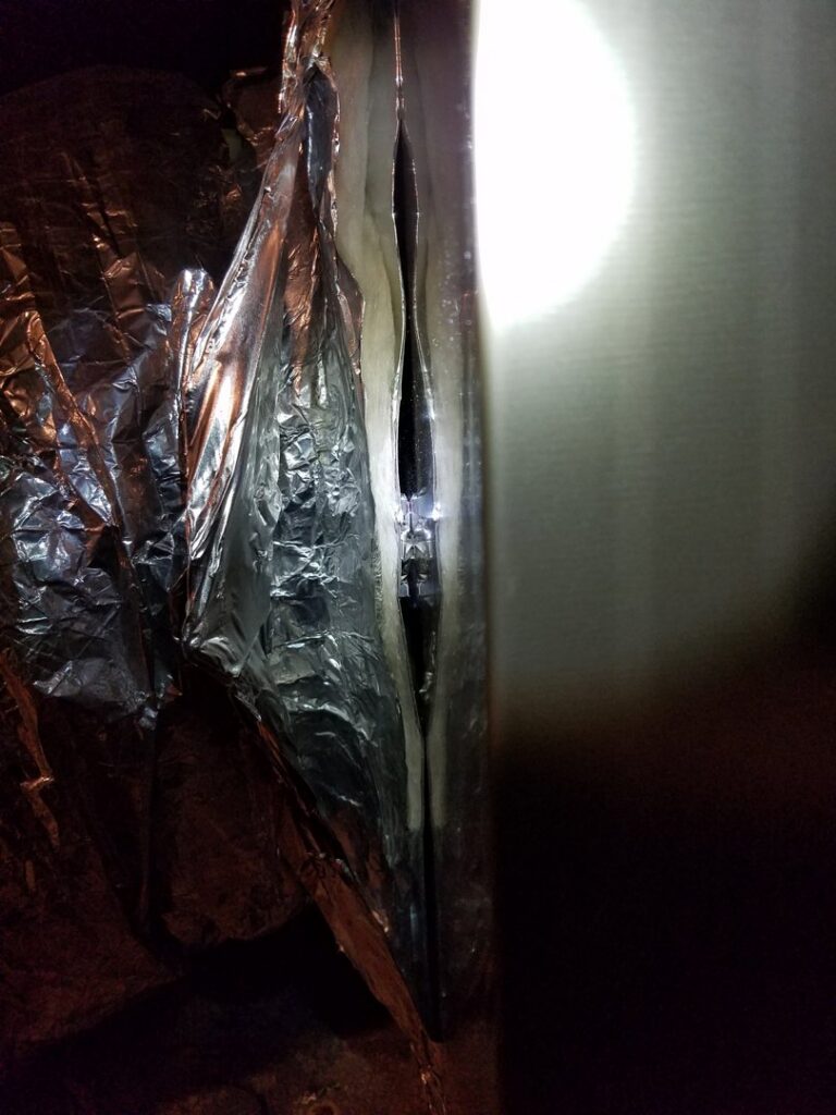 Close-up of insulated HVAC ductwork, possibly during installation or repair by Reliance Home Comfort in Hampton, VA.