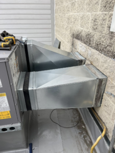 Newly installed HVAC ductwork connected to a commercial unit on a rooftop by WV Heating and Air in Morgantown, WV