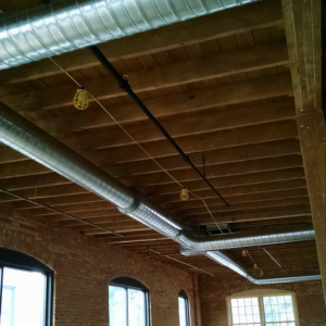 Newly installed spiral HVAC ductwork in a commercial building by SM Heating and Cooling in Rochester, NY