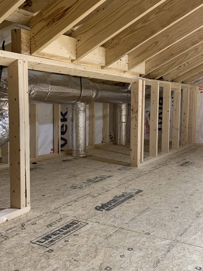 Insulated HVAC ductwork being installed in a new construction project by Symbiont Services in Englewood, FL.