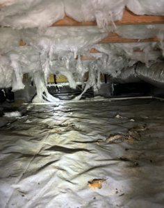 HVAC ductwork and insulation visible in a crawl space serviced by Greene Mechanical in Holly Springs, GA.