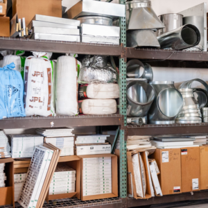 Shelves stocked with HVAC ductwork, insulation, and air filters at Child Air Conditioning & Heating Inc. in Mesa, AZ.