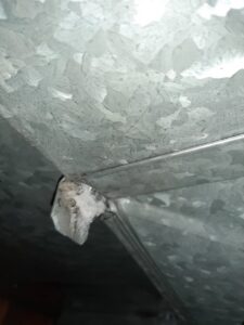 A close-up view inside metal HVAC ductwork, showing the interior components, inspected by Arrowseal of Billings HVAC in Billings, MT.
