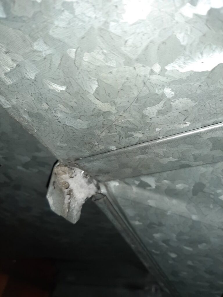 A close-up view inside metal HVAC ductwork, showing the interior components, inspected by Arrowseal of Billings HVAC in Billings, MT.