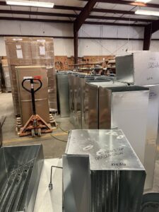 Stacks of metal HVAC ductwork and inventory in the warehouse of Central Heating & A/C Services, Inc. in Columbia, SC.