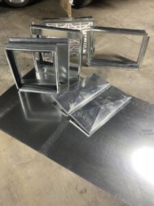 Various sheet metal ductwork components and air filters ready for installation by Butte Heating & Cooling in Rapid City, SD.
