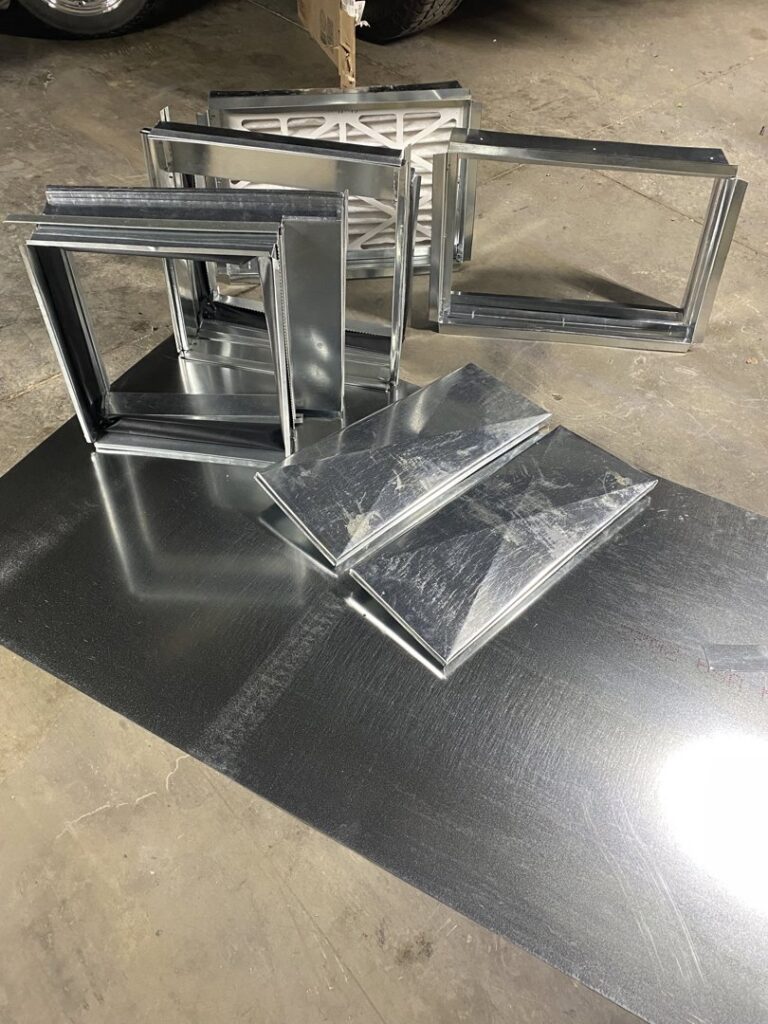 Various sheet metal ductwork components and air filters ready for installation by Butte Heating & Cooling in Rapid City, SD.