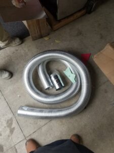 Coiled flexible ductwork and HVAC installation materials on the floor by HVAC Royal Service Inc in Chicago, IL.