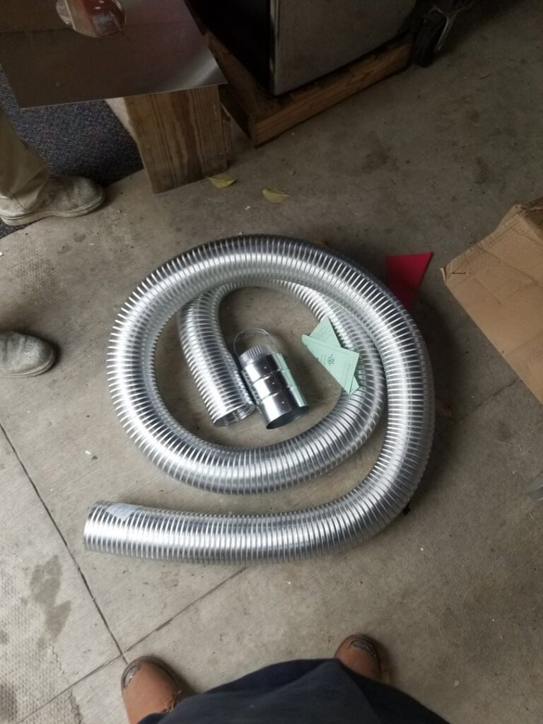 Coiled flexible ductwork and HVAC installation materials on the floor by HVAC Royal Service Inc in Chicago, IL.