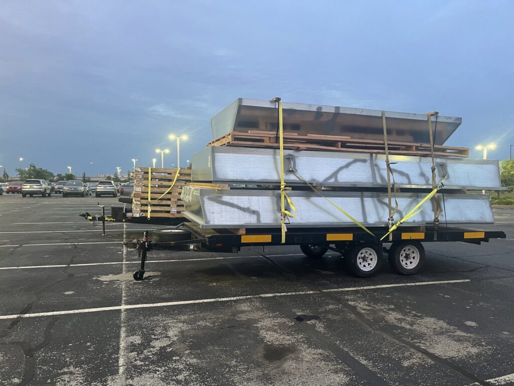 Large sheet metal HVAC ductwork materials loaded on a trailer for a project by STAR Heating Cooling Plumbing in Fishers, IN.