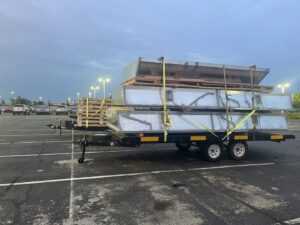 Large sheet metal HVAC ductwork materials loaded on a trailer for a project by STAR Heating Cooling Plumbing in Fishers, IN.