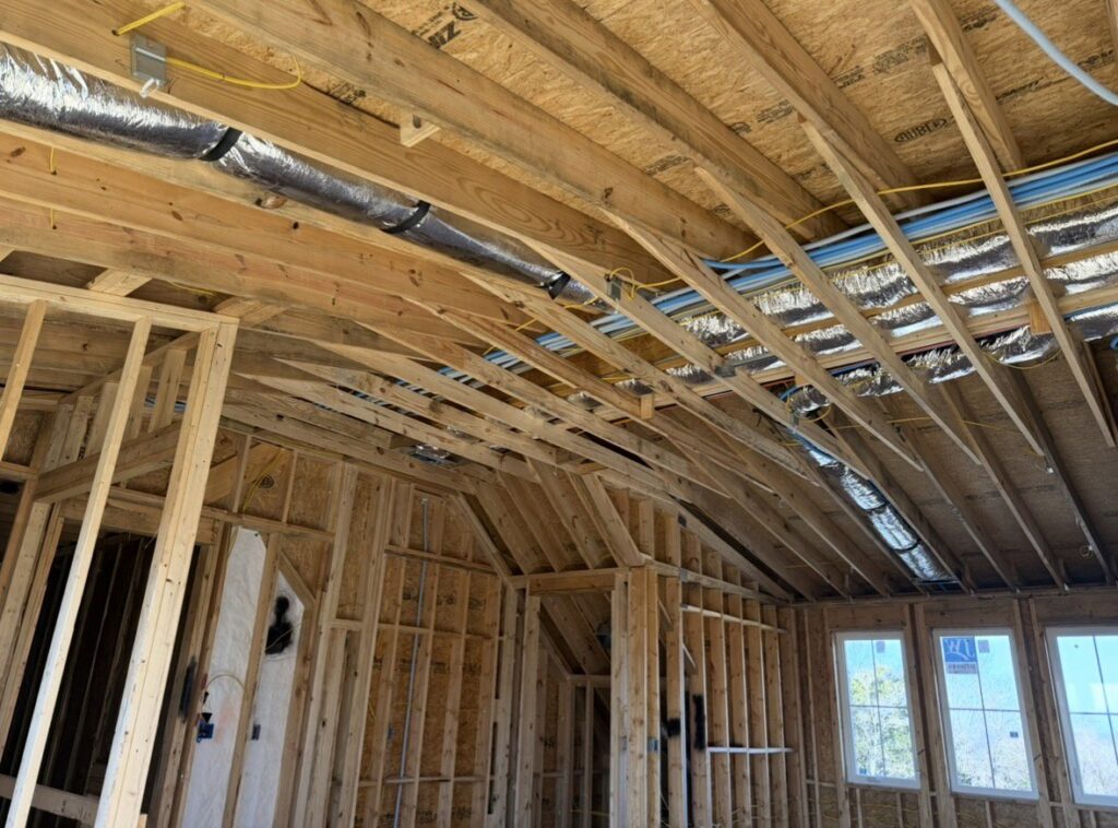 HVAC ductwork installation in the framing of a new construction home by Triune Air in Smithville, TN.