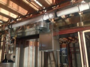 New HVAC ductwork and copper piping installed in a ceiling during construction by Furnace Doctors Heating & Air Conditioning LLC in Champaign, IL