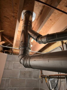 Metal HVAC ductwork and piping installed through a ceiling by Jackson Home Appliance Heating & Cooling in Omaha, NE