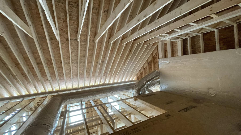 Long run of HVAC ductwork installed in a residential attic space by Paul Mechanical LLC in Merrimack, NH