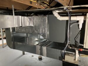 Newly installed HVAC ductwork and unit in a basement, completed by Manny Services in Syracuse, NY.