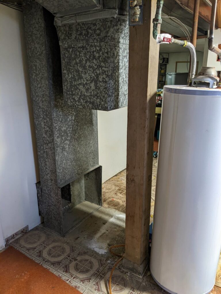 HVAC ductwork and a water heater installation in a basement by Arrowseal of Billings HVAC in Billings, MT.