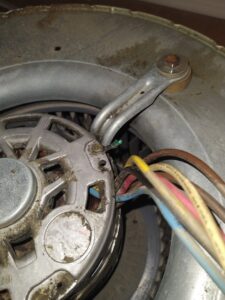 Close-up of HVAC electric motor wiring and components, showing repair work by Caddell Electric Co Inc in Dallas, TX.